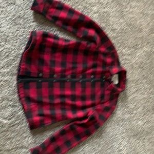 Buffalo plaid heavy cotton with black fleece lining. 2 front pockets.